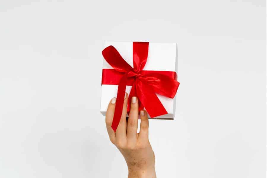 Photo of a hand holding a wrapped gift representing matching gifts