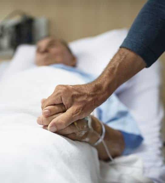 holding hand of hospice patient