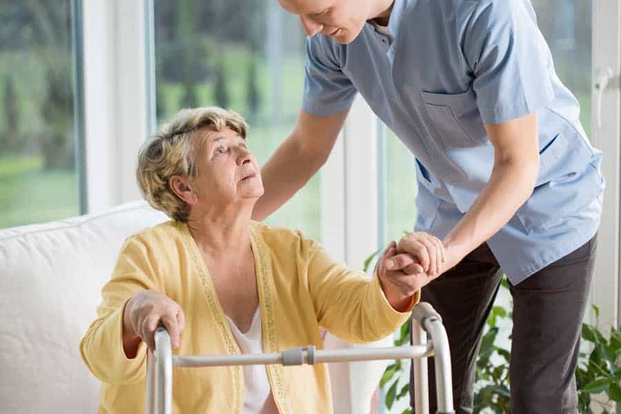 Hospice Care Patient being helped by home care medical staff