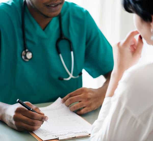 A patient discussing her medical insurance eligability with a hospice staff member