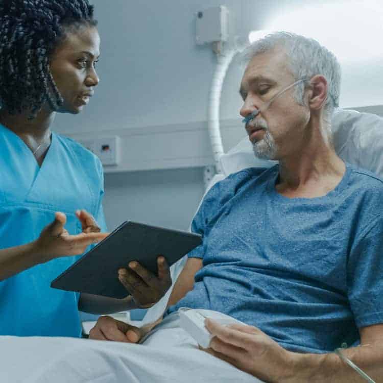 Patient in hospital bed at The Connecticut Hospice Licensed Inpatient Hospital