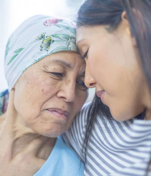 A daughter hugging her mother who has cancer