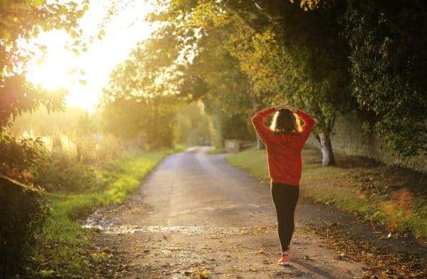 Caregiver taking time for a walk outside in the morning sun.