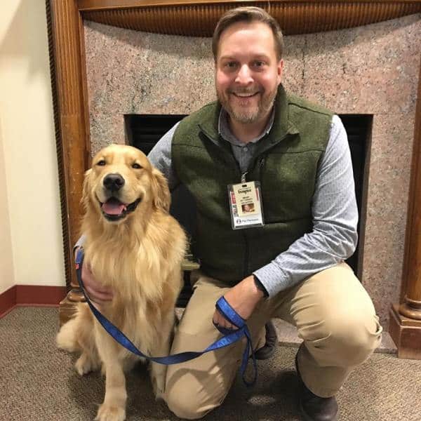 Smiling Pet Therapy Volunteer with smiling therapy dog at Connecticut Hospice