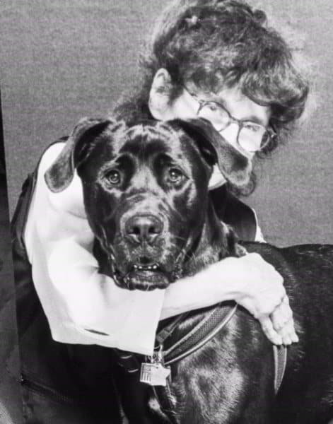 Pet Therapy Volunteer hugs therapy dog