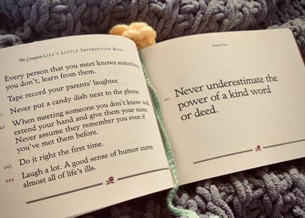Open book displays adage "Never underestimate the power of a kind word or deed."