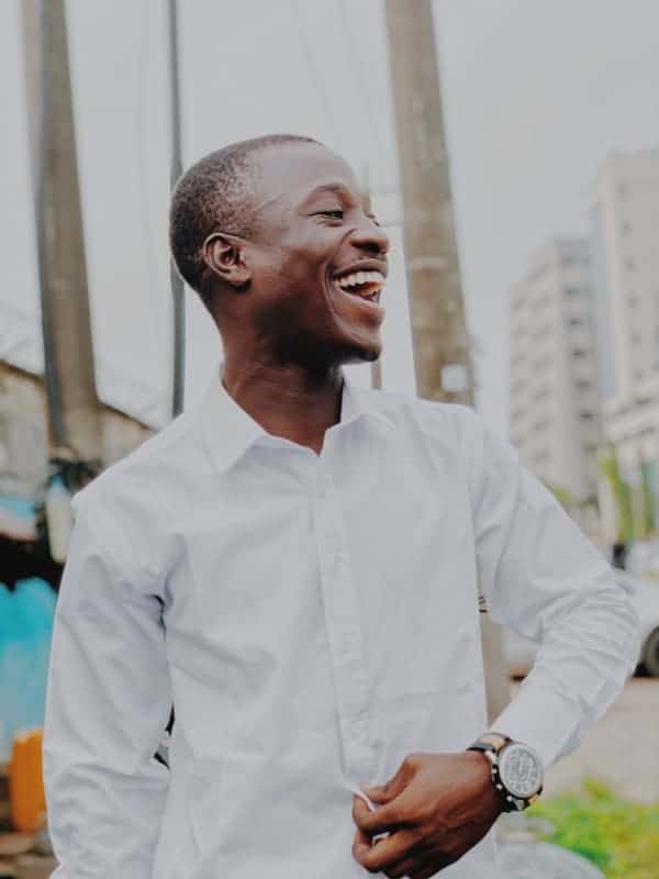 Young man in white shirt laughing 