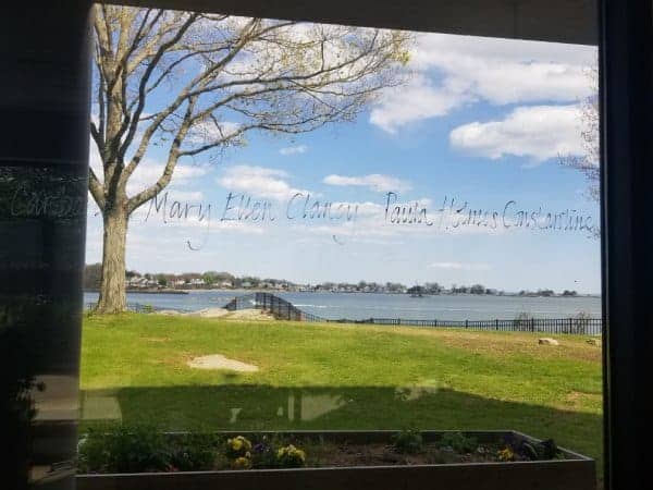 Handwritten names on window overlooking The Connecticut Hospice grounds and Long Island Sound