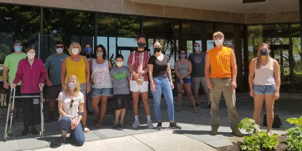 Fourteen family members stand at entrance of Connecticut Hospice to say goodbye