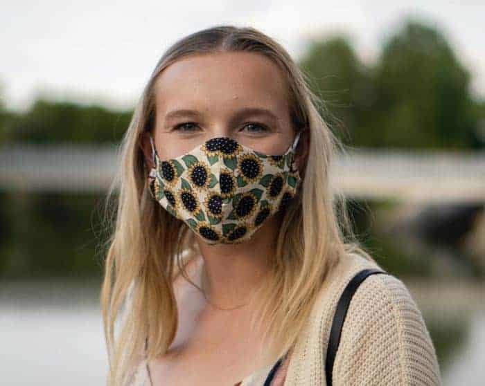 woman wearing sunflower print covid mask