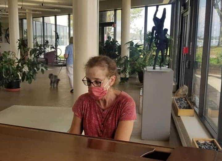 Volunteer Plays the Piano in Lobby at CT Hospice