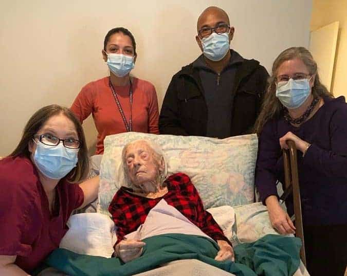 Hospice patient surrounded by care team