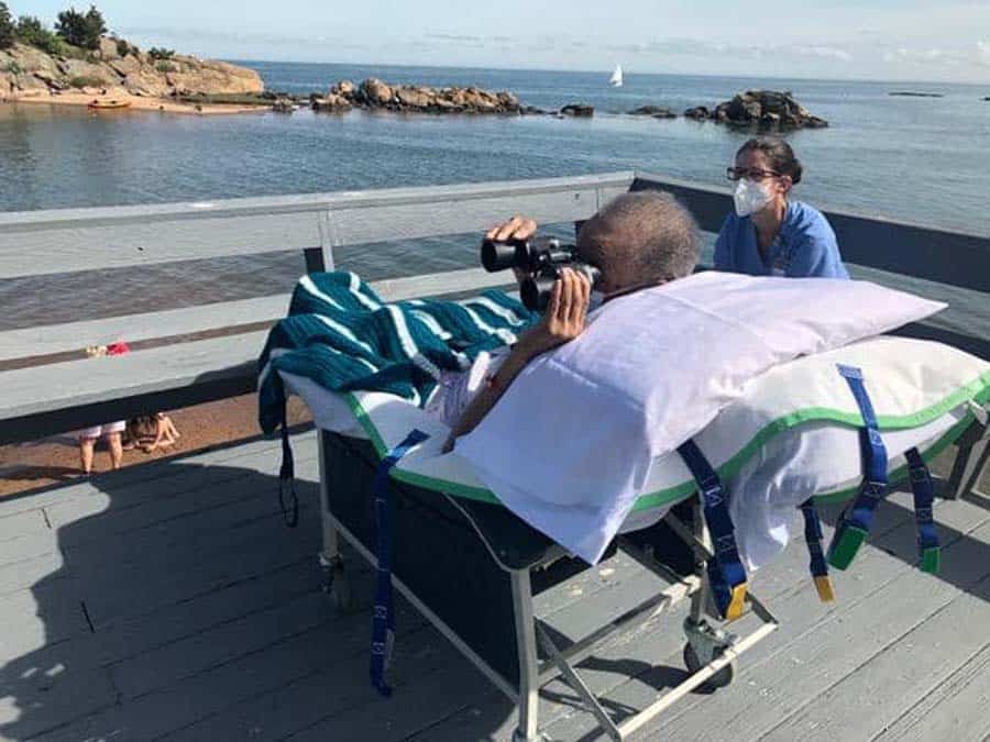 Patient with binoculars outside birdwatching