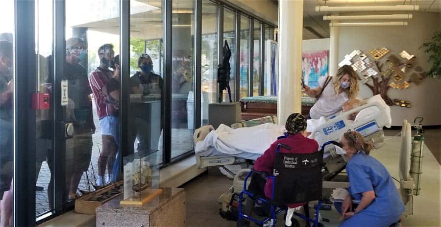 A Connecticut Hospice family says good-bye to their dad:grandfather singing “Country Roads,” through the glass