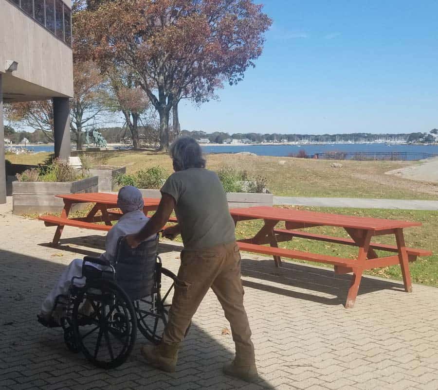 Connecticut Hospice Volunteer Taking a patient on a stroll Outside