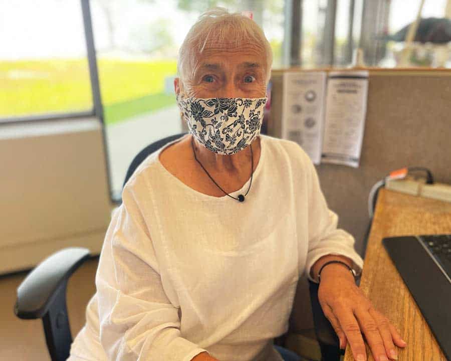 Hospice volunteer works at the checkin desk