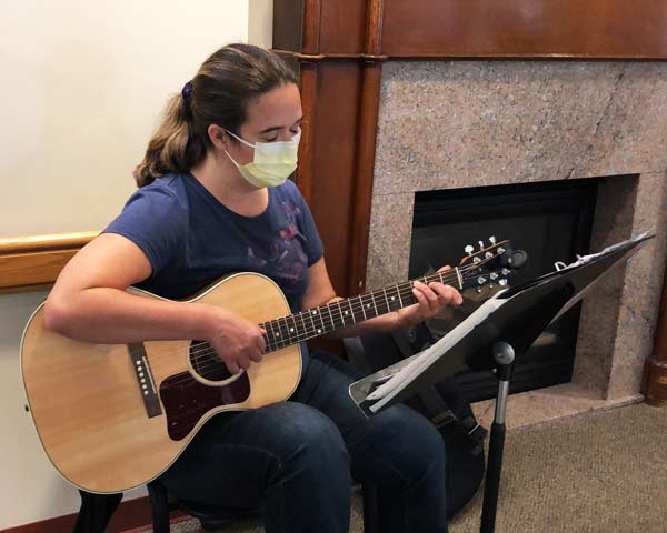 musician volunteer plays the guitar