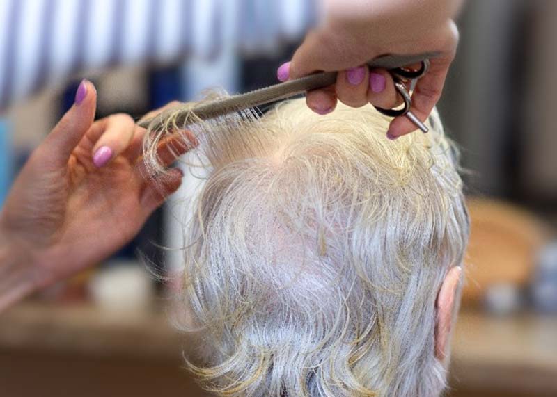 elderly woman getting a  haircut