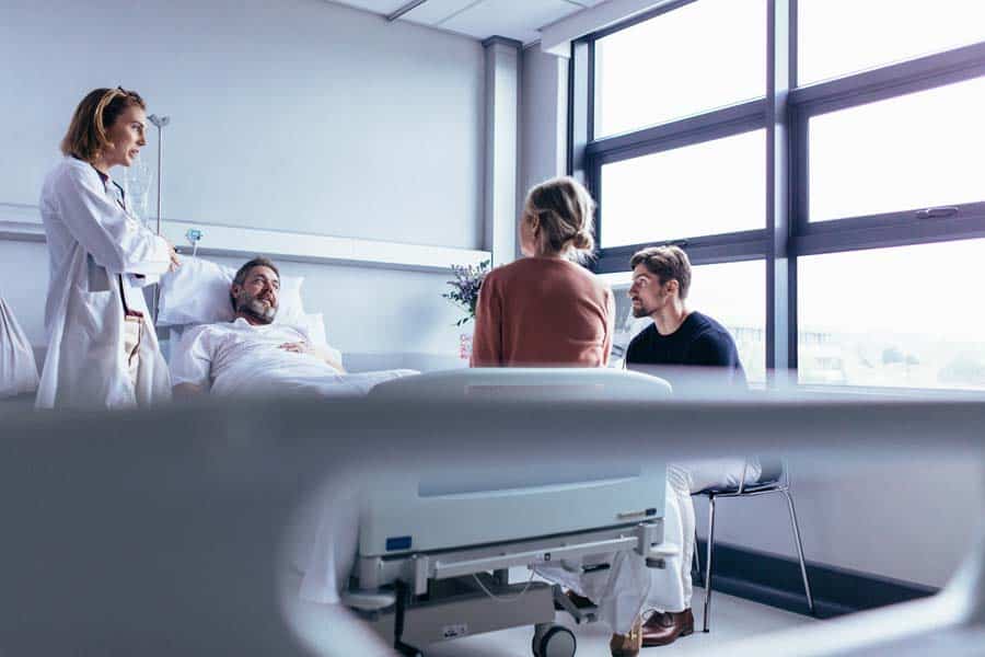 Female doctor visiting patient in hospital room