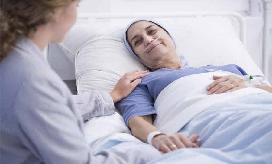 female chemo patient-speaking with doctor-from hospital bed