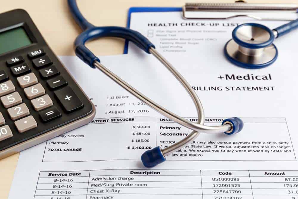Medical bill with calculator and stethescope concept representing Healthcare Costs