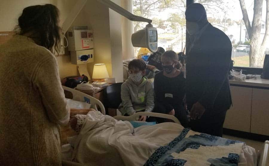 Chaplain at bedside with family