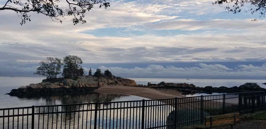 Clouds across blue sky above double beach in Branford, CT