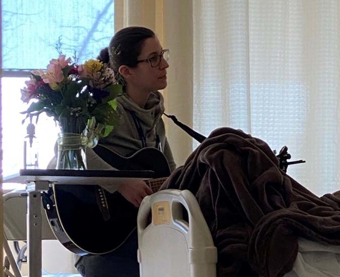 Connecticut Hospice guitarist playing at bedside