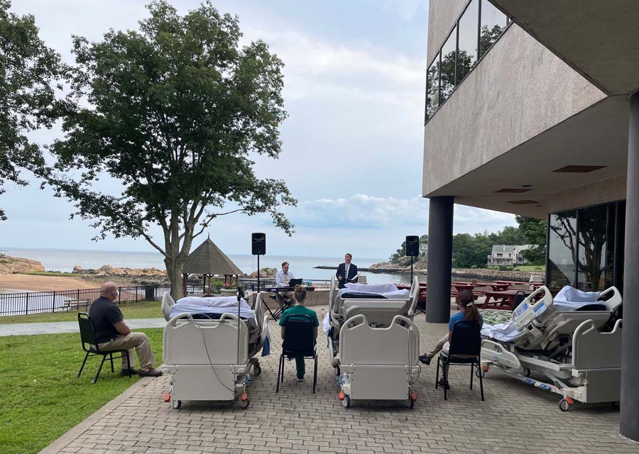 Connecticut Hospice patients in beds enjoying outdoor concert