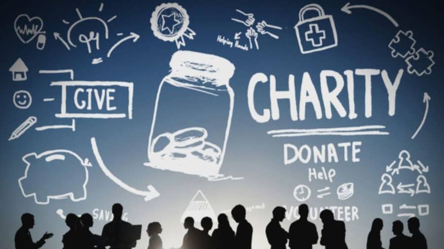 Graphic with words about charity and silhouettes of volunteers