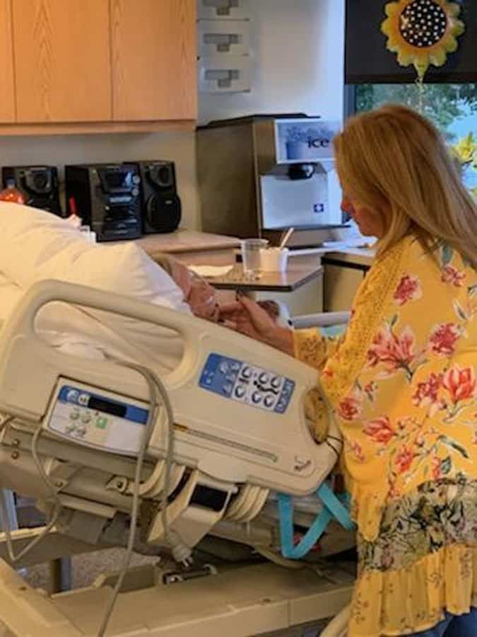 Daughter talking with Mom in hospital bed
