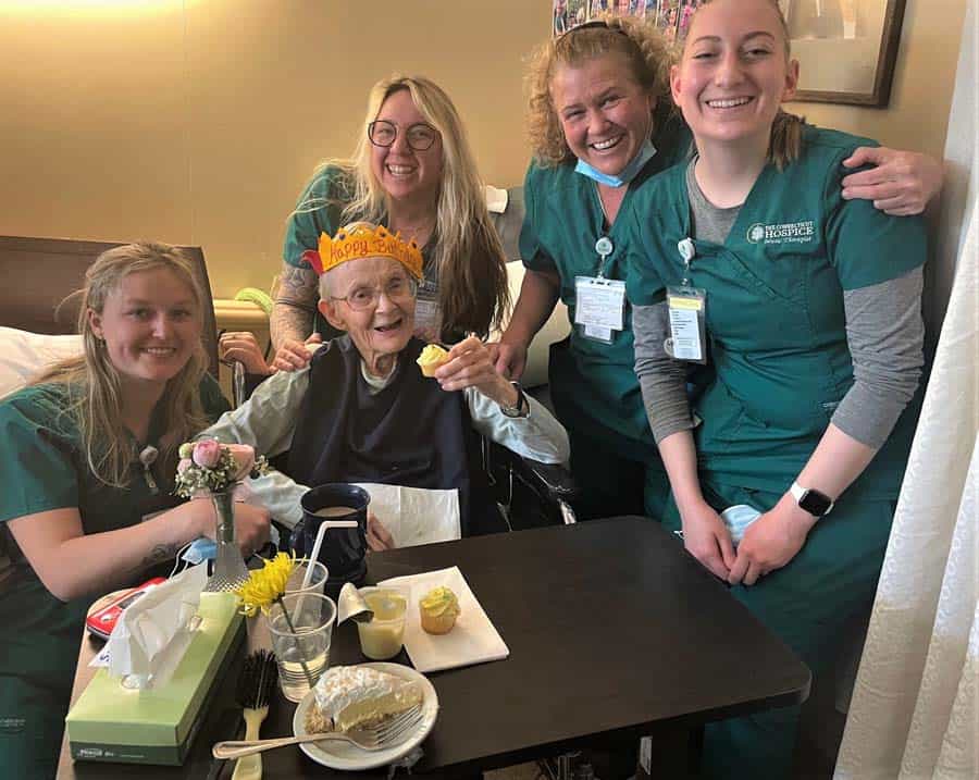 Facility care team with patient celebrating her birthday