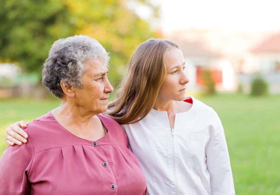 Elderly woman with her nurse in the nature