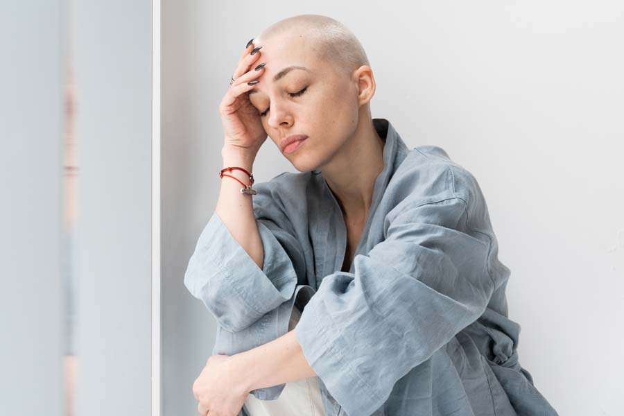 bald female patient looking distressed