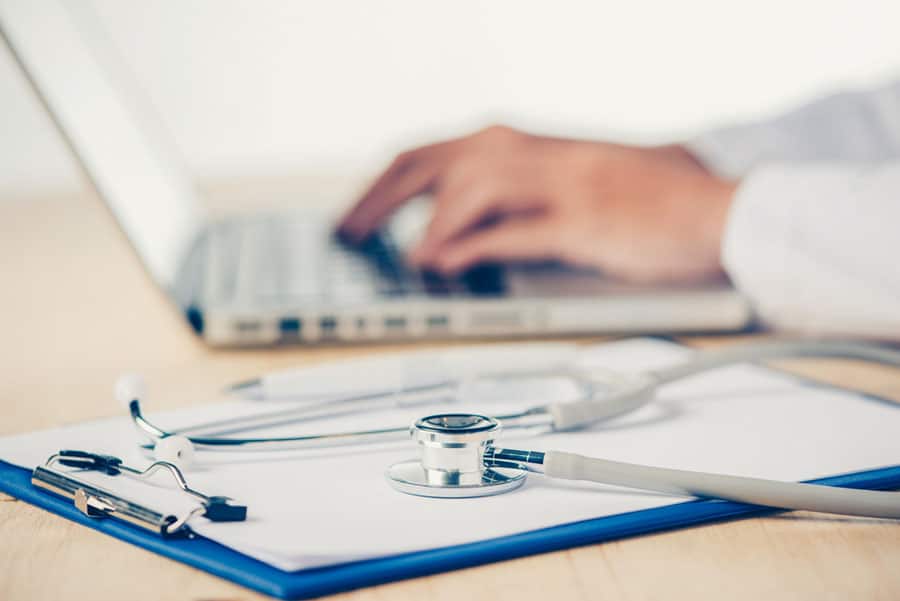 Medicine doctor's working table. Focus on stethoscope.