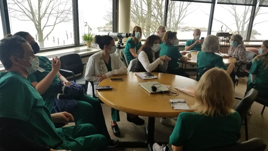 Healthcare students sitting at tables learning