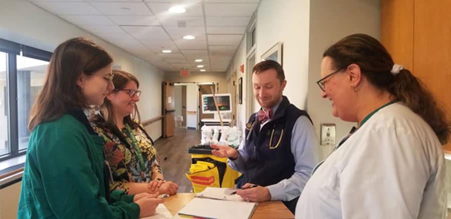 medical staff teaching student on floor at Connecticut Hospice