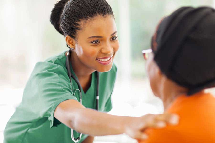 Palliative Care nurse comforting a patient