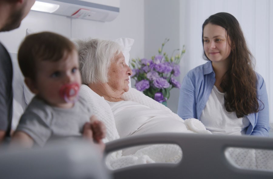 family visiting hospice patient in bed
