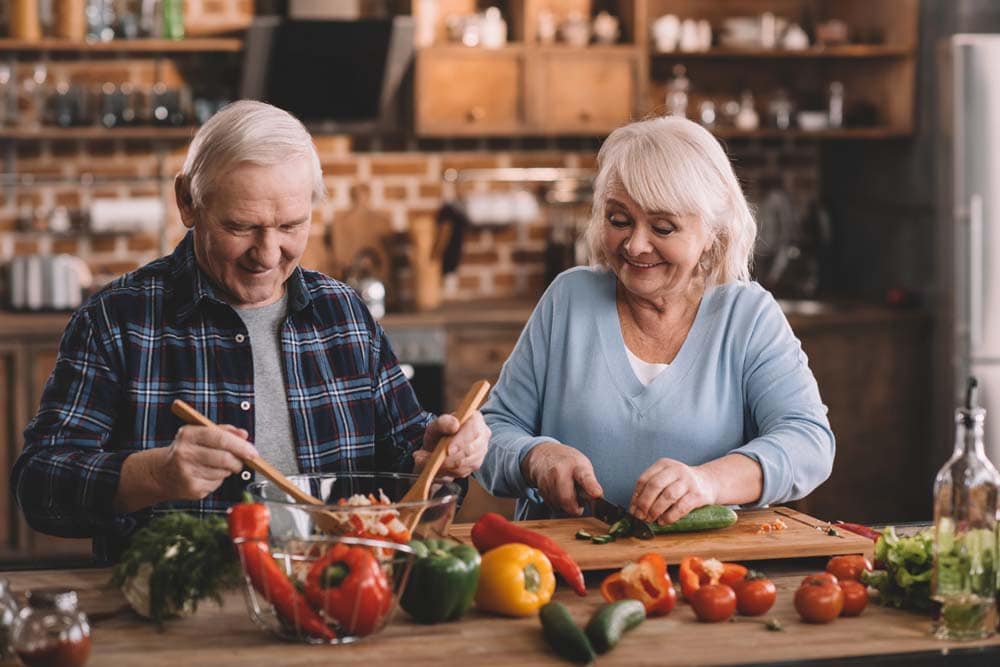 Elderly couple cooking together