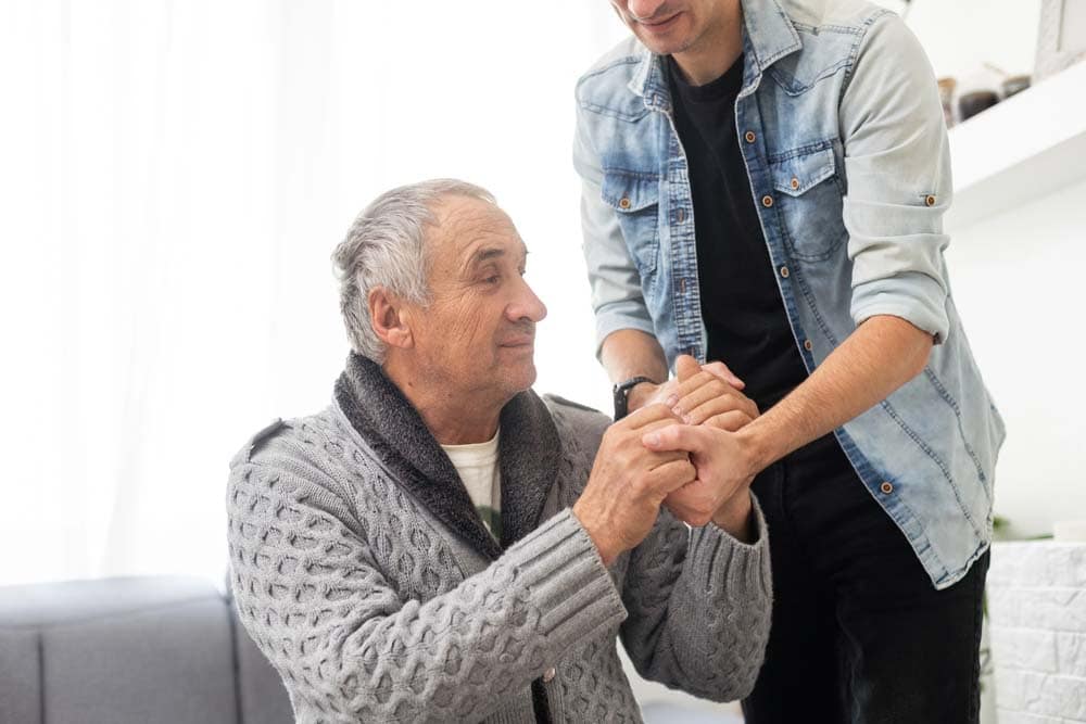 Elderly son takes care of elderly father